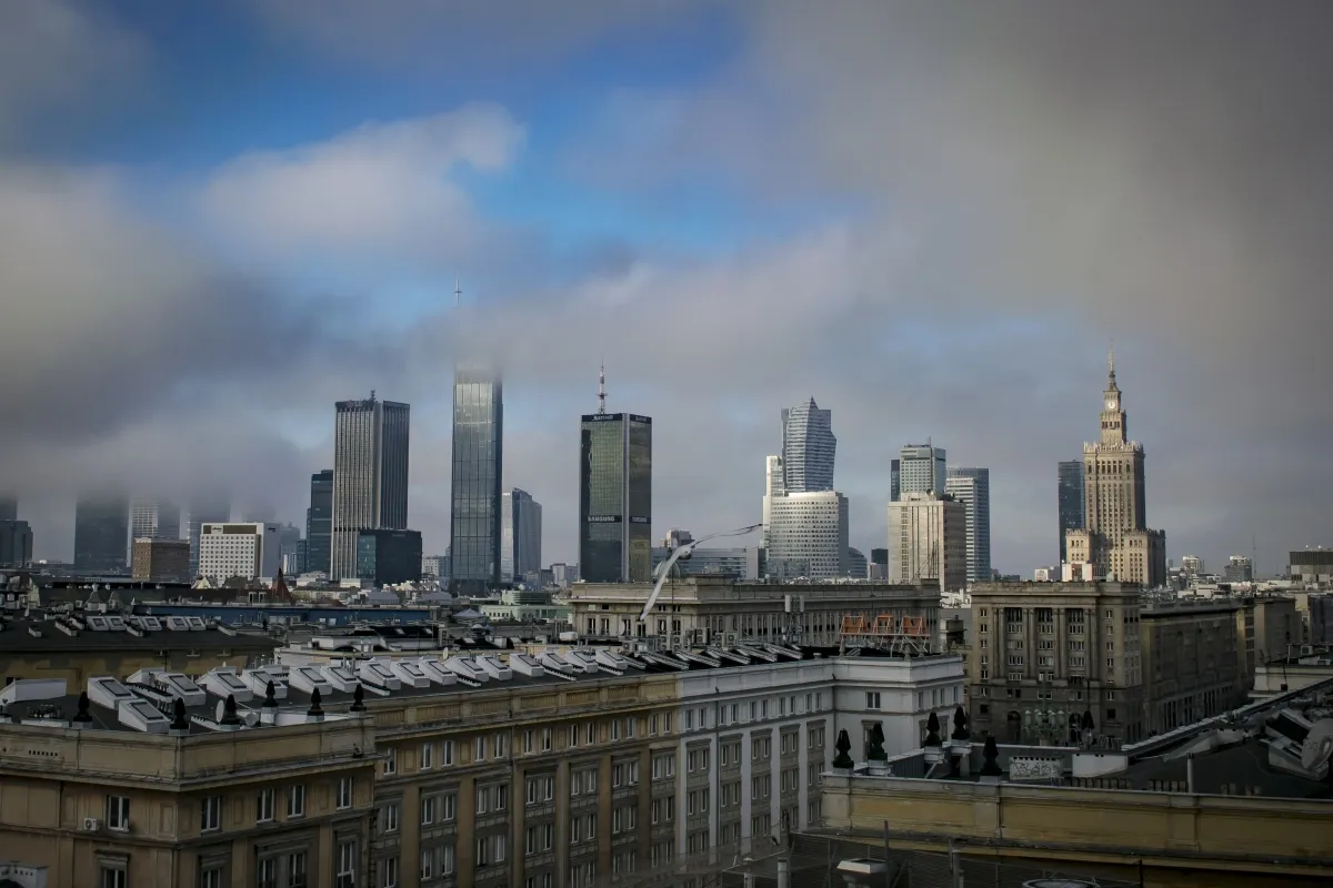 Warsaw skyline under low clouds with the Palace of Culture and Science at right